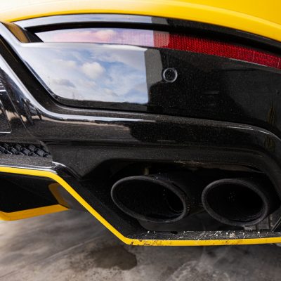 Dual exhaust of yellow sport car suv.
